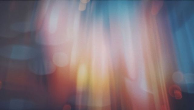 Vibrant abstract light streaks with pastel bokeh