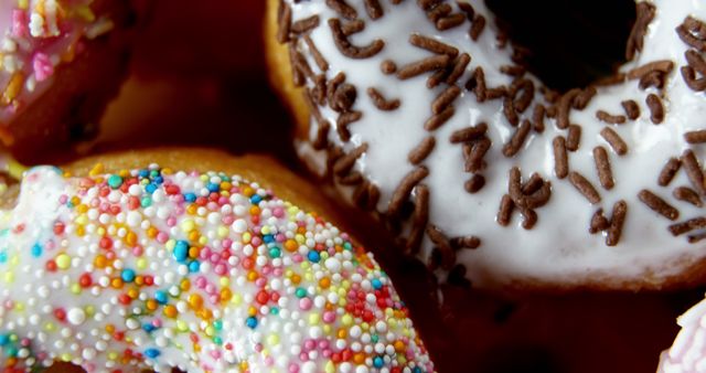Close-up of Colorful Iced Doughnuts with Sprinkles and Chocolate Shavings - Download Free Stock Images Pikwizard.com