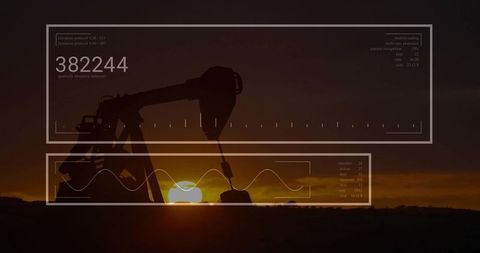 Silhouette of oil pump jack with analytics overlay at sunset