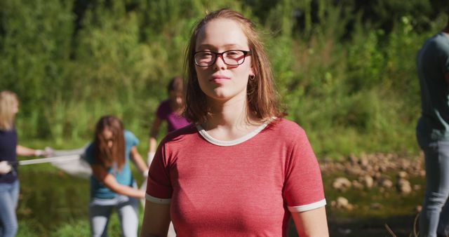 Young Woman Volunteering for River Cleanup on Sunny Day - Download Free Stock Images Pikwizard.com