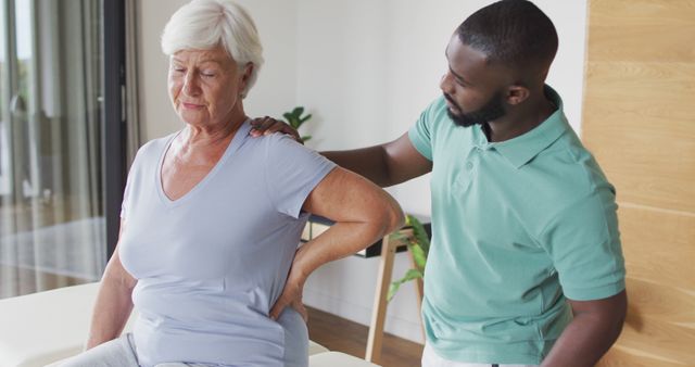 Image of caucasian senior woman practicing with african american male physiotherapist. seniors health and nursing home lifestyle concept digitally generated image.