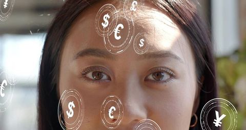 Female professional gazing with floating currency holograms symbolizing global digital finance innov
