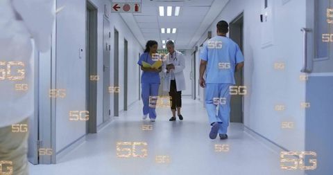 Medical Team Walking in Hospital Corridor with Digital 5G Symbols