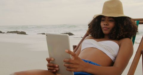 Young Woman Relaxing with Tablet on Tranquil Beach - Download Free Stock Images Pikwizard.com