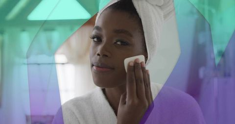 Woman Applying Cotton Pad During Morning Skincare Routine at Bathroom Mirror for Self-Care