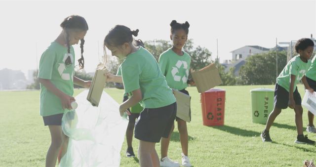 Happy diverse schoolchildren wearing recycle tshirts cleaning sports field at elementary school - Download Free Stock Photos Pikwizard.com
