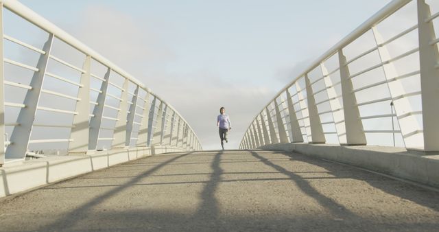 Man Jogging on Urban Bridge in Morning Light - Download Free Stock Images Pikwizard.com