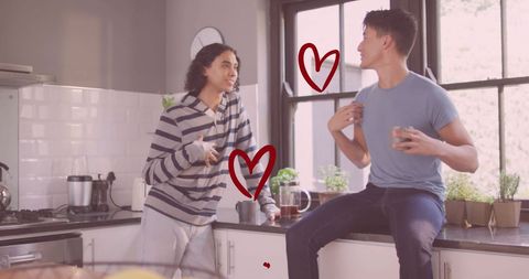 Happy Gay Couple Laughing in Modern Kitchen with Hearts
