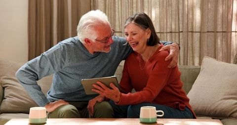 Happy Senior Couple Enjoying Technology at Home