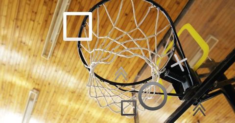 Overhead basketball hoop and net beneath wood gym ceiling, showing bracket and lights