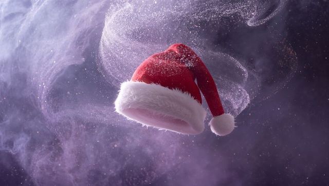 Floating red Santa hat in glittery purple smoke with velvet fur trim festive levitation