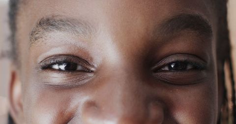 Close-Up of Young Girl Smiling Joyfully Indoors
