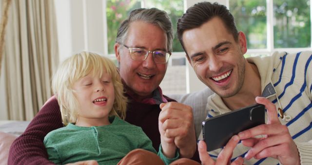 Three Generations of Happy Family Enjoying Time Together with Digital Device - Download Free Stock Images Pikwizard.com