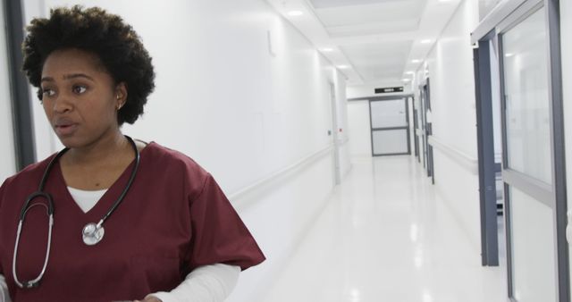 Healthcare Worker in Hospital Corridor Wearing Scrubs with Stethoscope - Download Free Stock Images Pikwizard.com