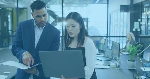 Two Business Professionals Collaborating in Modern Office Setting