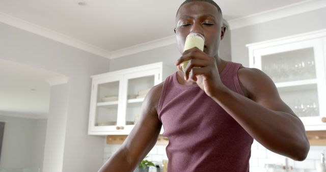 Young Man Drinking Healthy Smoothie in Home Kitchen - Download Free Stock Images Pikwizard.com