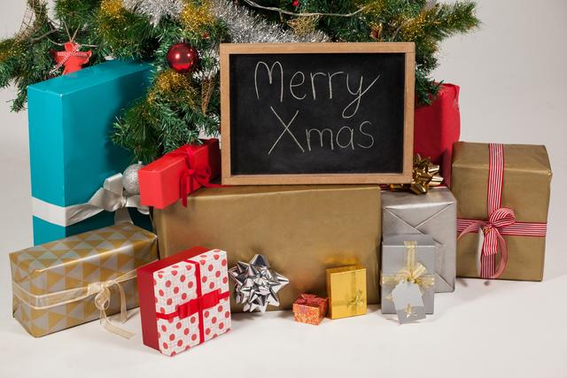 Perfect for holiday greeting cards, festive advertisements, and Christmas-themed social media posts. Captures the essence of Christmas with a cheerful message, beautifully wrapped presents, and a decorated tree.