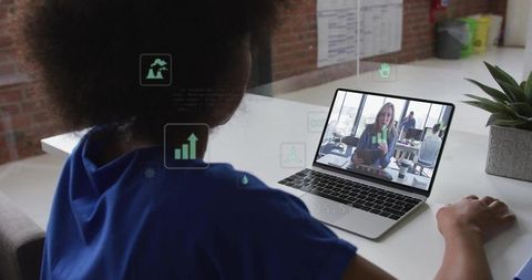 Woman joining remote meeting with AR analytics overlays on laptop in coworking office