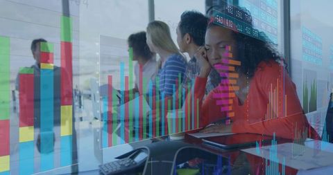 Business Team Analyzing Digital Data Charts in Office Meeting