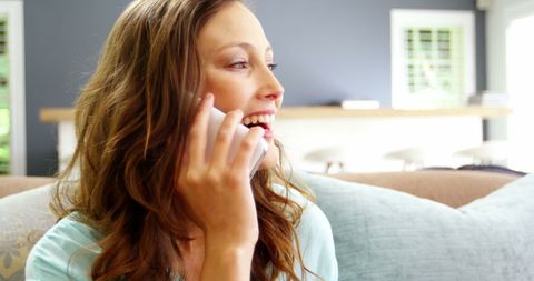 Happy woman relaxing at home enjoying phone call