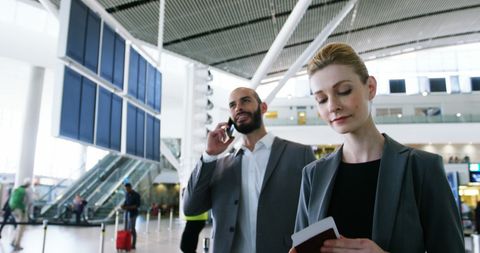 Business travelers at airport terminal preparing for departure