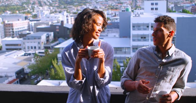 Young Couple Enjoying Coffee on Balcony Overlooking Cityscape - Download Free Stock Images Pikwizard.com