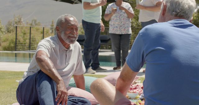 Senior Friends Enjoying Outdoor Picnic by Pool - Download Free Stock Images Pikwizard.com