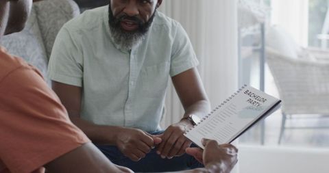 Friends planning bachelor party discussing checklist together