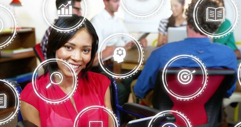 Smiling Businesswoman in Modern Digital Office with Technology Icons