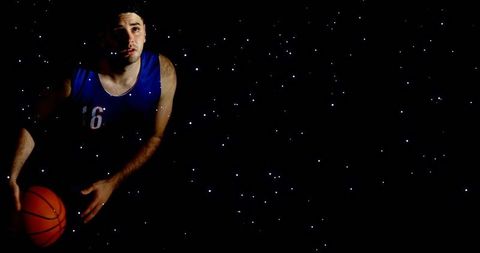 Male Basketball Player Dribbling Under Starry Night