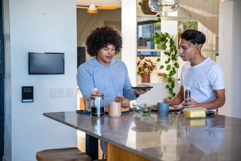 Diverse friends sharing breakfast time in modern kitchen