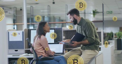 Colleagues discussing bitcoin and digital currency in modern office