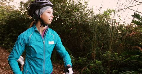 Female mountain biker exploring forest landscape
