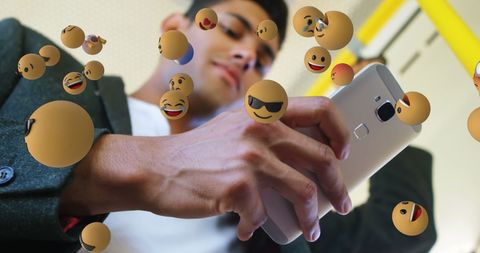 Young Male Commuter Using Phone Amidst Emoji Graphics - Download Free Stock Images Pikwizard.com