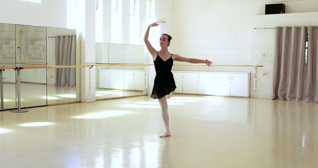 Ballerina is doing exercises in dancing hall 
