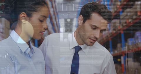 Diverse Professionals Analyzing Digital Financial Data in Warehouse