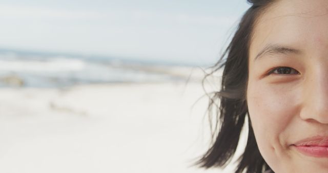 Smiling Woman Enjoying Beach Day with Windblown Hair - Download Free Stock Images Pikwizard.com