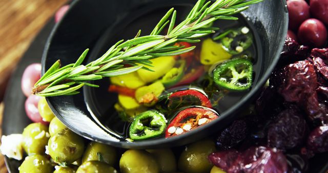 Close-up of Fresh Herb, Pickled Olives, and Chili Peppers in Olive Oil - Download Free Stock Images Pikwizard.com