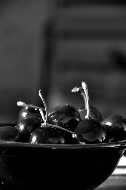 This image of fresh cherries in a bowl, rendered in black and white, makes for an excellent addition to food-related marketing materials, nutrition blogs, and healthy eating campaigns. It can also be used in kitchen décor, illustrating simplicity and natural beauty.