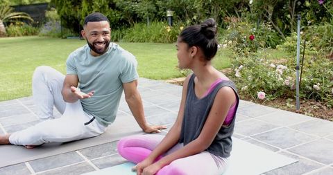 Father and Daughter Doing Yoga Circa Garden Harmony