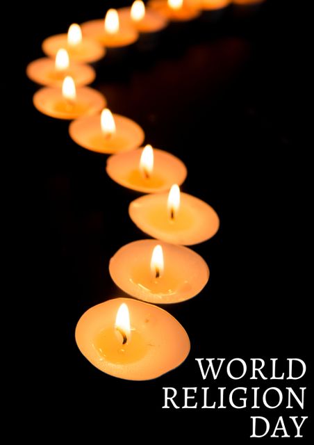 Close-up of illuminated tea lights with world religion day in darkroom. digital composite, text, communication and religion concept.