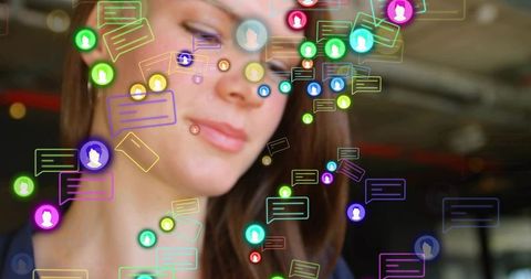 Woman engaging with neon chat bubbles and digital avatars for workplace collaboration