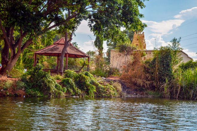 Scenic View of Riverside Gazebo Near Historical Temple - Download Free Stock Photos Pikwizard.com