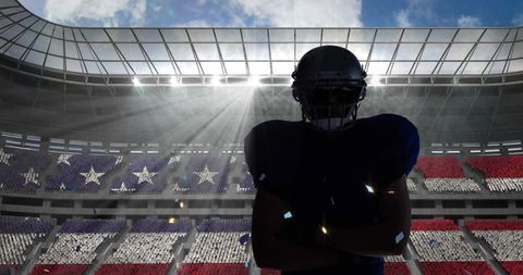 Silhouetted Football Player in Stadium with USA Flag Background