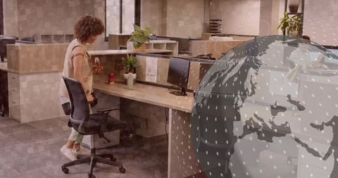 Professional woman preparing for work next to modern cubicle