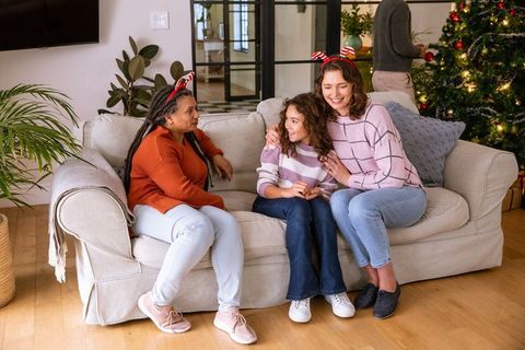 Diverse Family Celebrating Around Christmas Tree