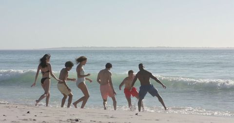 Diverse Friends Enjoying an Energizing Beach Day Under the Sun - Download Free Stock Images Pikwizard.com