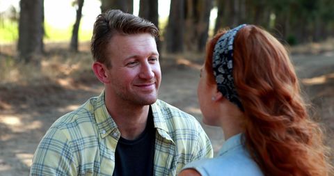 Couple Enjoying Conversation Outdoors by Tree Lined Path