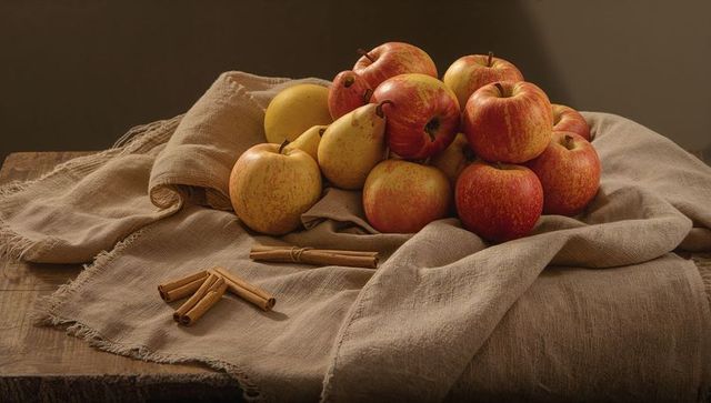 Cozy display of apples and pears with cinnamon sticks