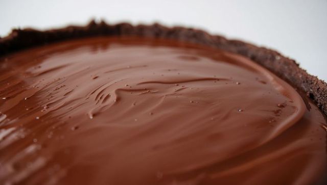 Glossy Chocolate Ganache Tart with Dark Cocoa Crumb Crust Closeup Dessert Smooth Texture